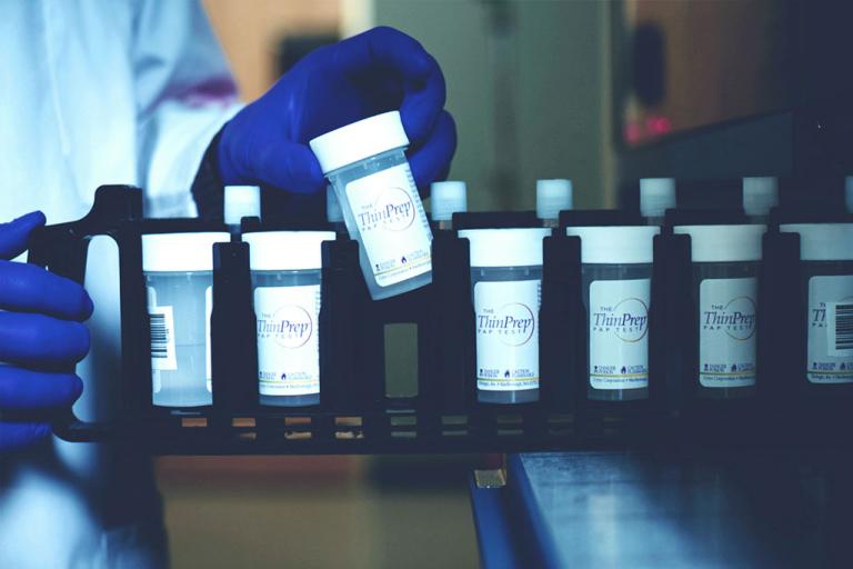 Female patient smiling to healthcare professional in examination room
